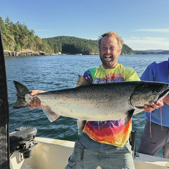 Kyle holding a large fish.