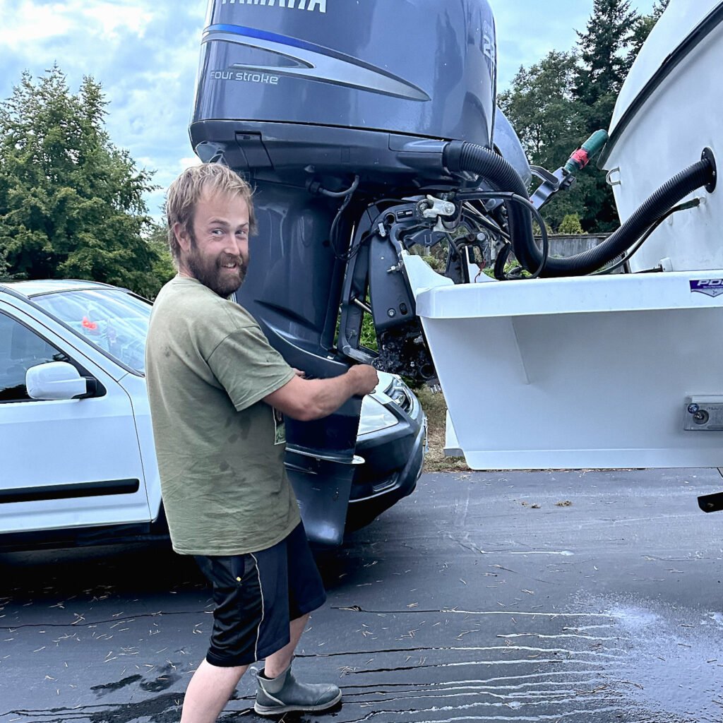 Kyle Prescott working on a boat engine.